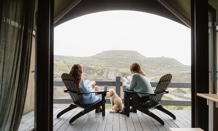 Enjoy a moment of peace on your private deck overlooking Llechwedd quarry, Zip World Llechwedd, and the mountains and valleys of Eryri (Snowdonia)